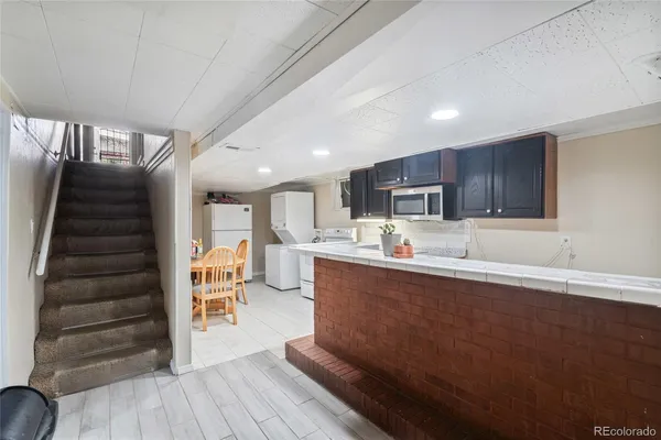 a kitchen with stainless steel appliances granite countertop a sink a stove and a refrigerator