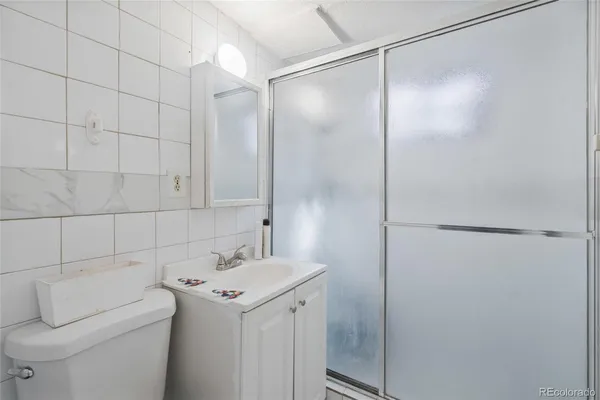 a bathroom with a sink and mirror with toilet
