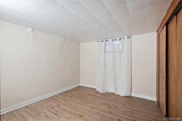 a view of a room with wooden floor