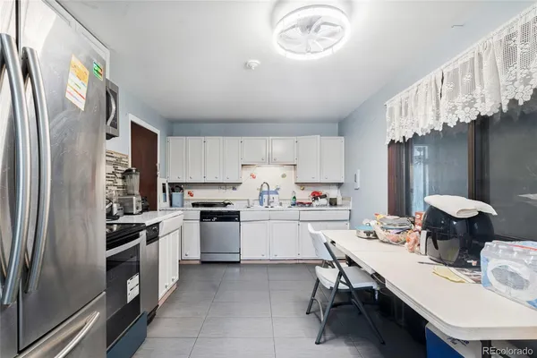 a kitchen with a sink appliances and cabinets