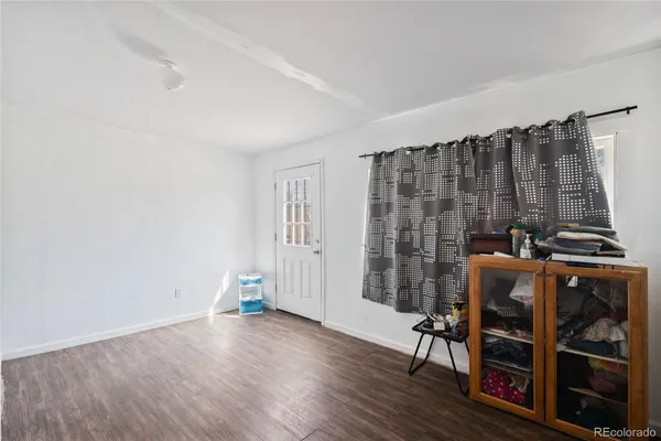 a view of a livingroom with furniture and hardwood floor