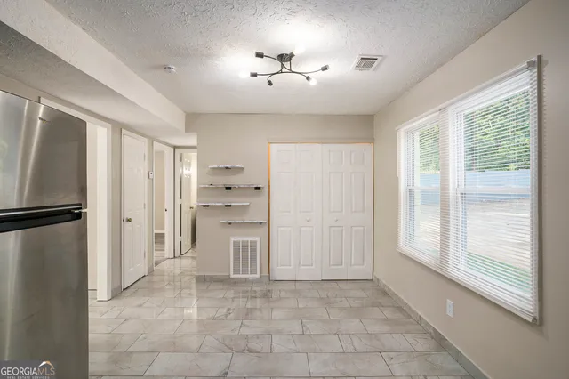 a view of an empty room with wooden floor
