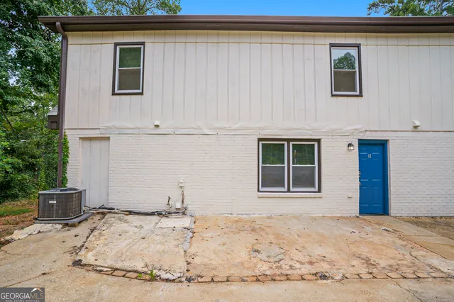 a view of a house with a yard and sitting space