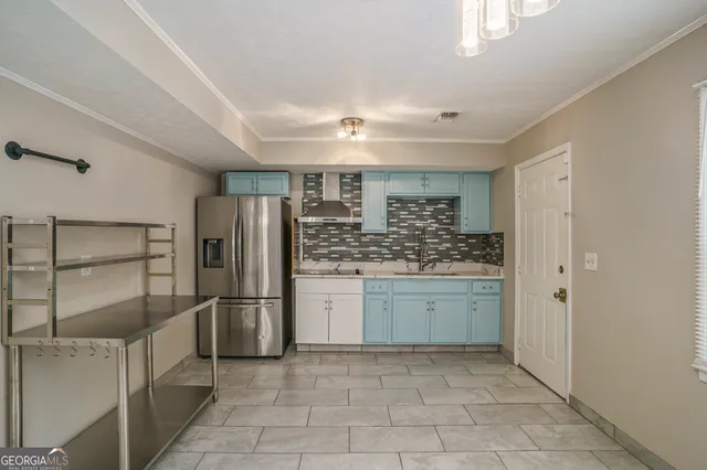 a kitchen with refrigerator and cabinets