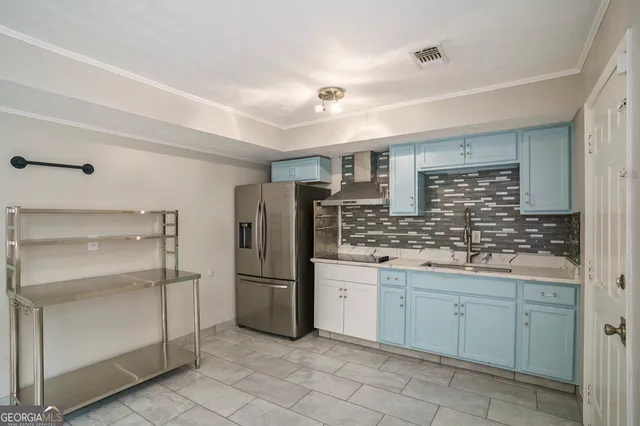 a kitchen with cabinets and stainless steel appliances