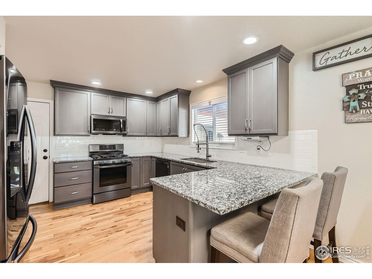 135 Falcon Circle Mead, CO 80542 - Photo 12 of 27 a kitchen with stainless steel appliances granite countertop a sink refrigerator and microwave