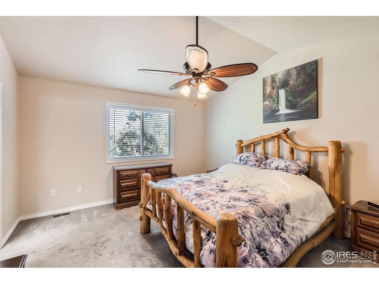 135 Falcon Circle Mead, CO 80542 - Photo 16 of 27 a bedroom with a bed a window and dresser