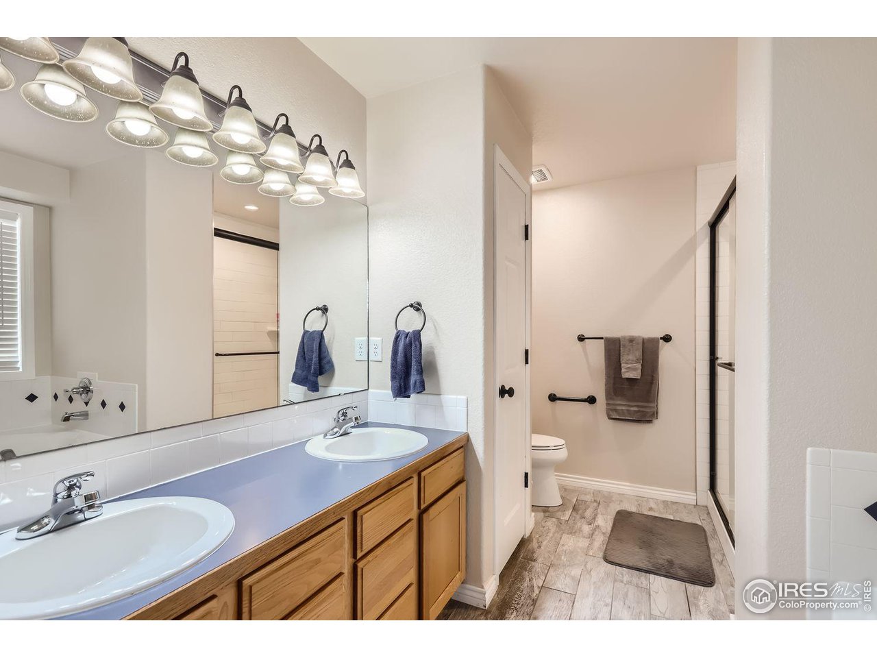 135 Falcon Circle Mead, CO 80542 - Photo 17 of 27 a bathroom with a sink vanity granite and a mirror