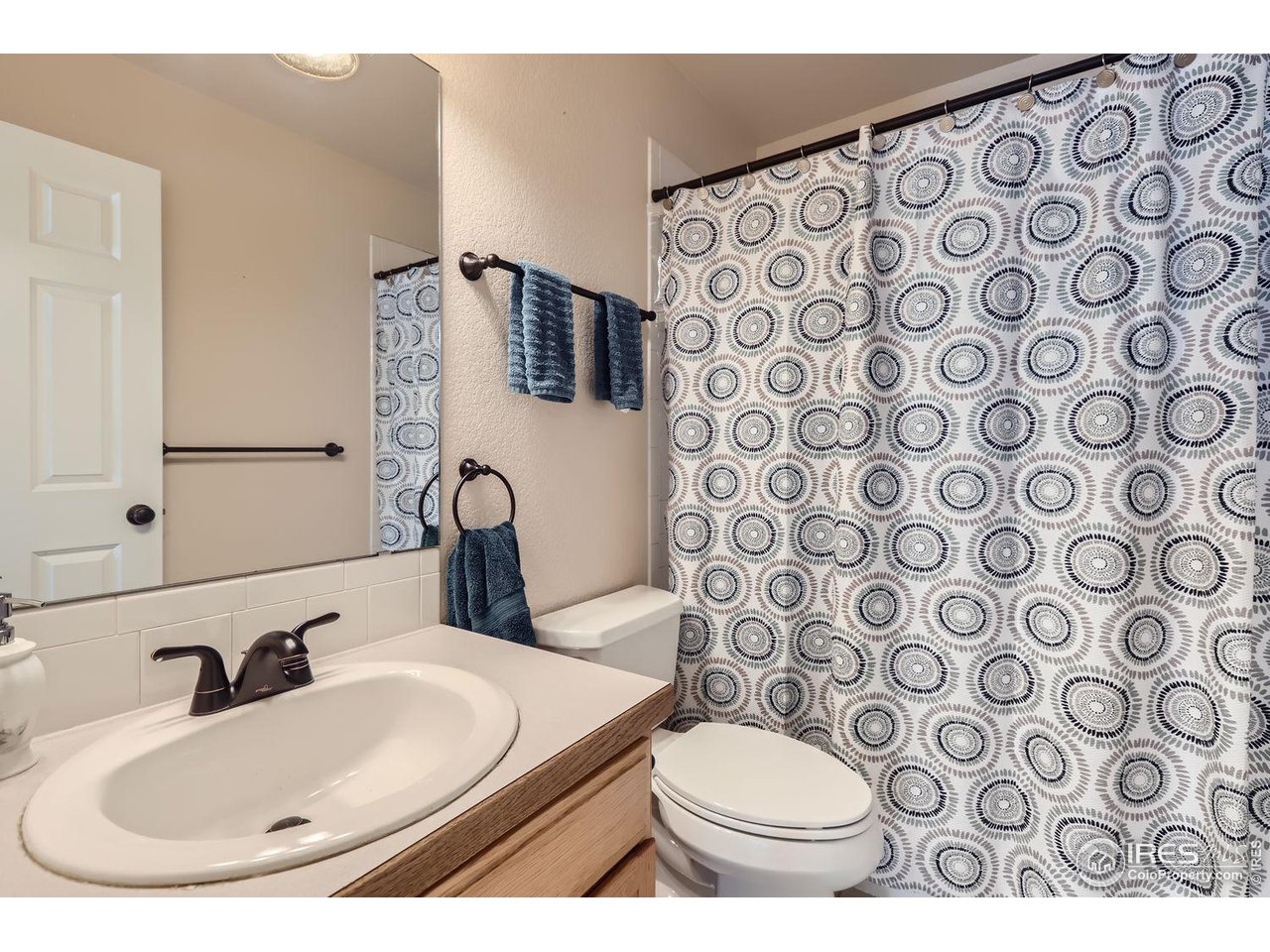 135 Falcon Circle Mead, CO 80542 - Photo 21 of 27 a bathroom with a toilet sink and mirror