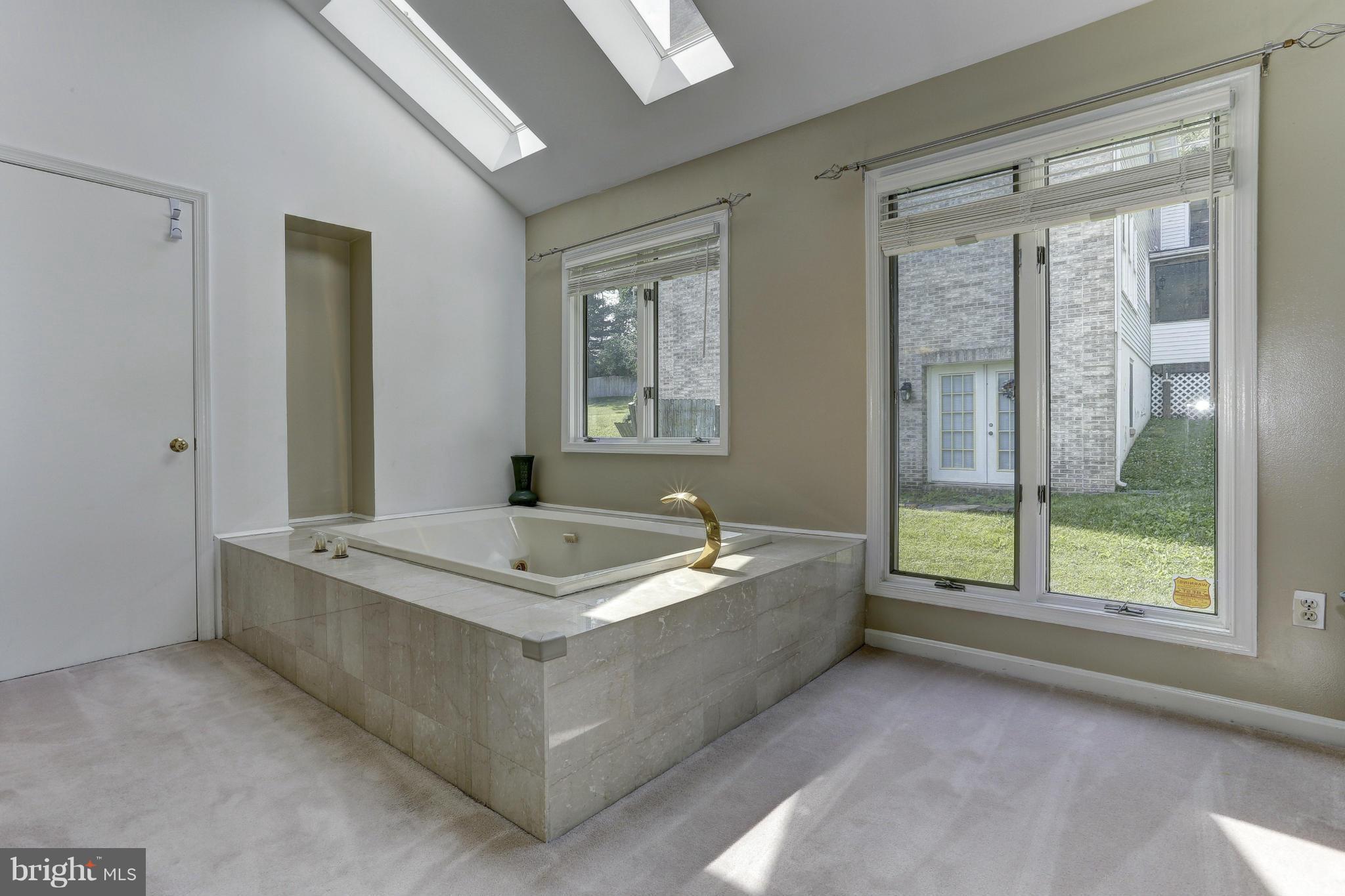3978 View Top Road Ellicott City, MD 21042 - Photo 14 of 30 a bath tub sitting in a bathroom next to a window