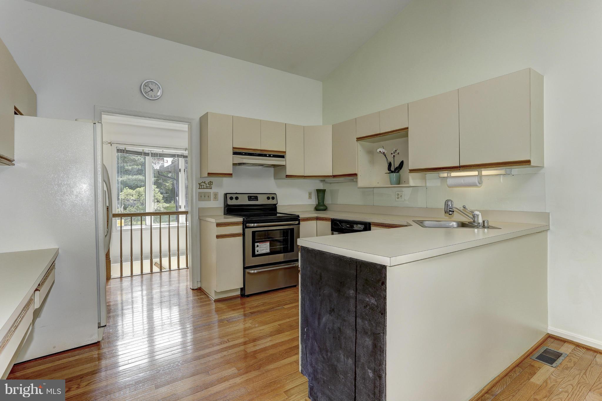 3978 View Top Road Ellicott City, MD 21042 - Photo 8 of 30 a kitchen with a sink a stove and cabinets