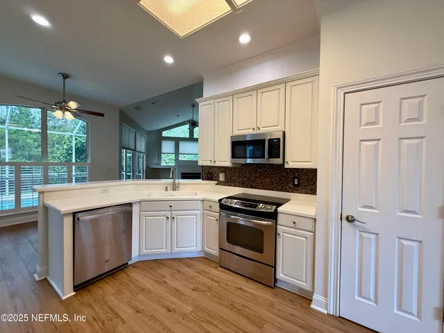 a view of an empty room and wooden floor