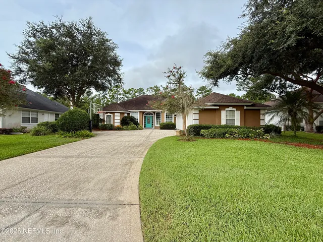 an empty room with wooden floor cabinet and windows