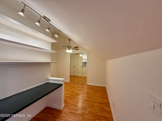 a bathroom with a double vanity sink a mirror and a bathtub