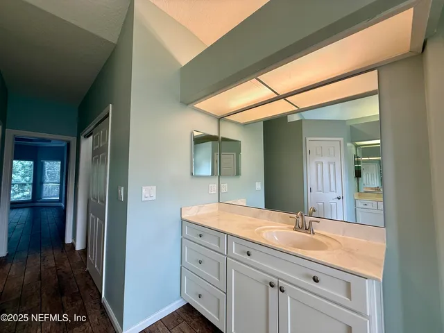 a spacious bathroom with a bathtub and a sink