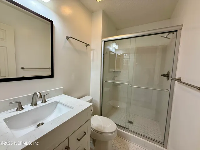 an empty room with closet and windows