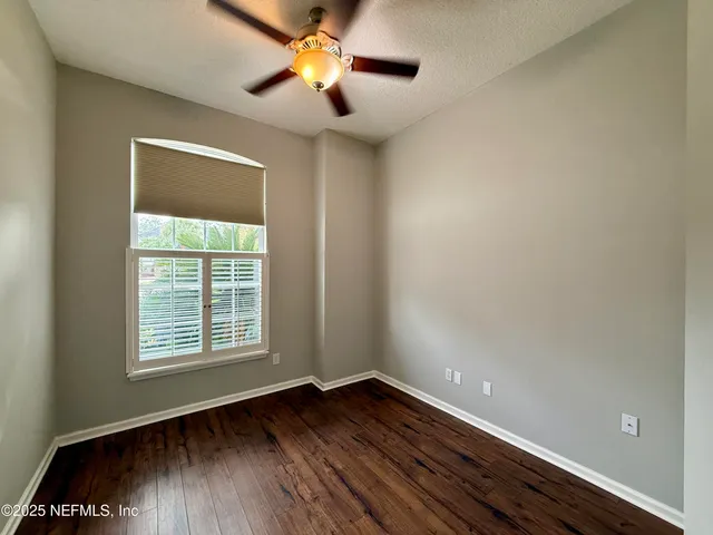 a view of a room with wooden floor