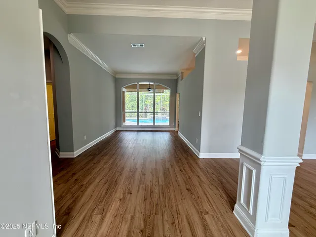 a kitchen with white cabinets and a stove top oven