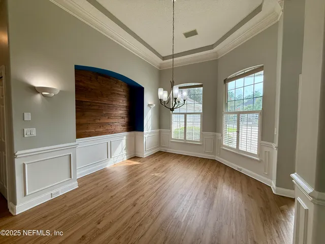 a view of empty room with fireplace and wooden floor