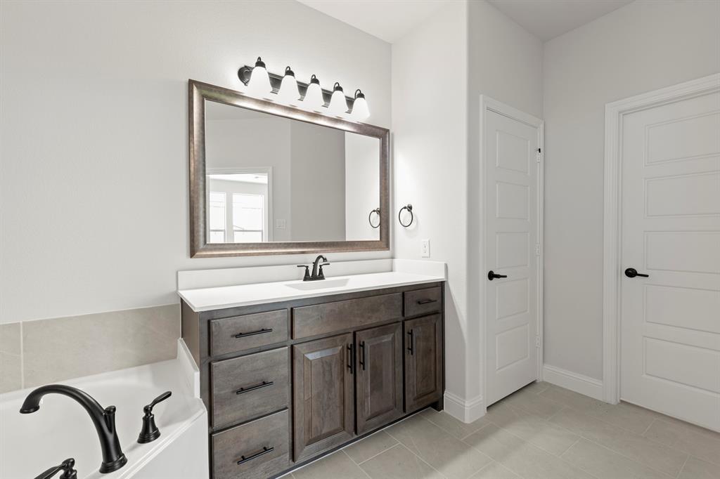 505 Alto Avenue Forney, TX 75126 - Photo 11 of 32 a bathroom with a double vanity sink mirror and