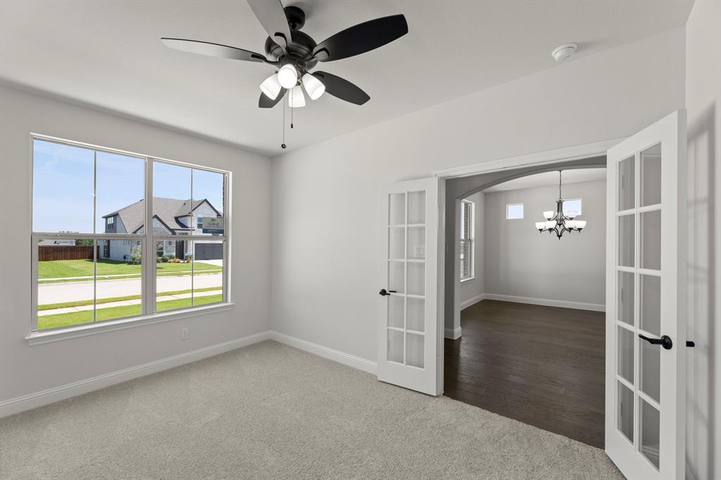 505 Alto Avenue Forney, TX 75126 - Photo 13 of 32 en empty room with windows and ceiling fan