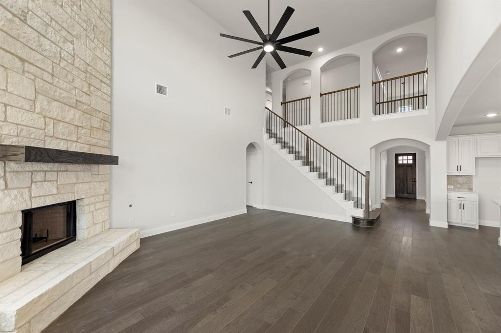 505 Alto Avenue Forney, TX 75126 - Photo 6 of 32 an empty room with wooden floor fireplace and windows