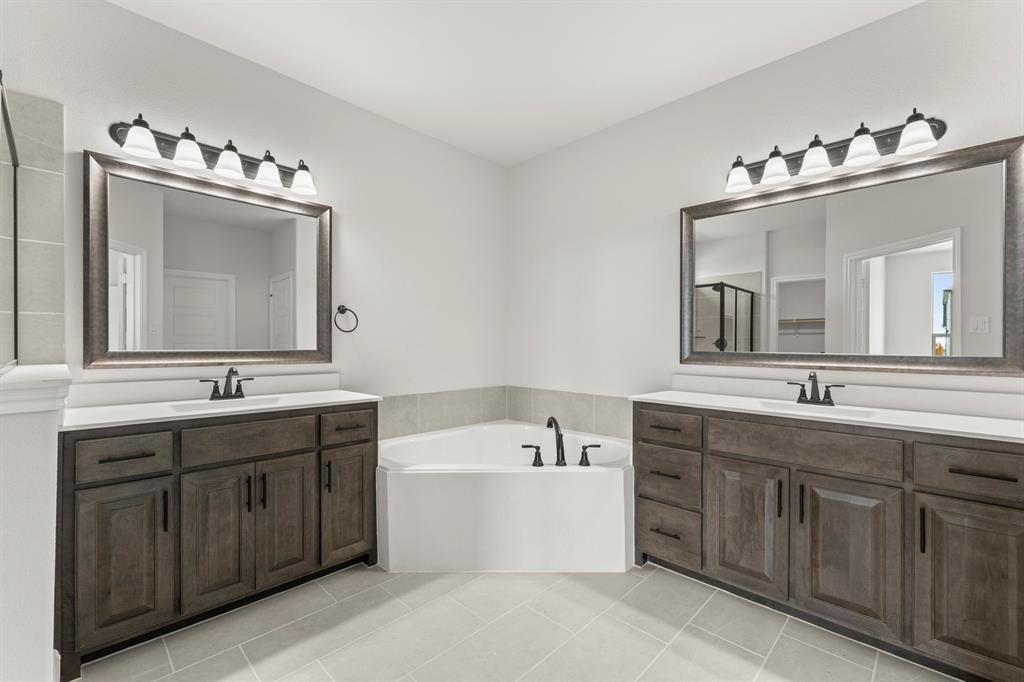 505 Alto Avenue Forney, TX 75126 - Photo 9 of 32 a bathroom with a double vanity sink mirror and bathtub