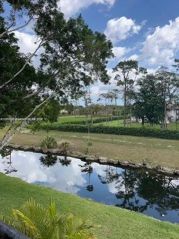 an aerial view of a house with a yard and lake view
