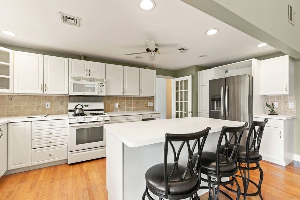 29 Marshall Road Easton, MA 02356 - Photo 16 of 31 a kitchen with stainless steel appliances a table chairs and a refrigerator
