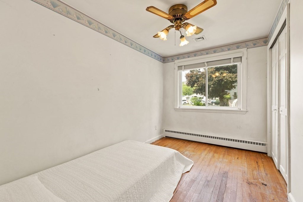 29 Marshall Road Easton, MA 02356 - Photo 19 of 31 an empty room with wooden floor chandelier fan and windows