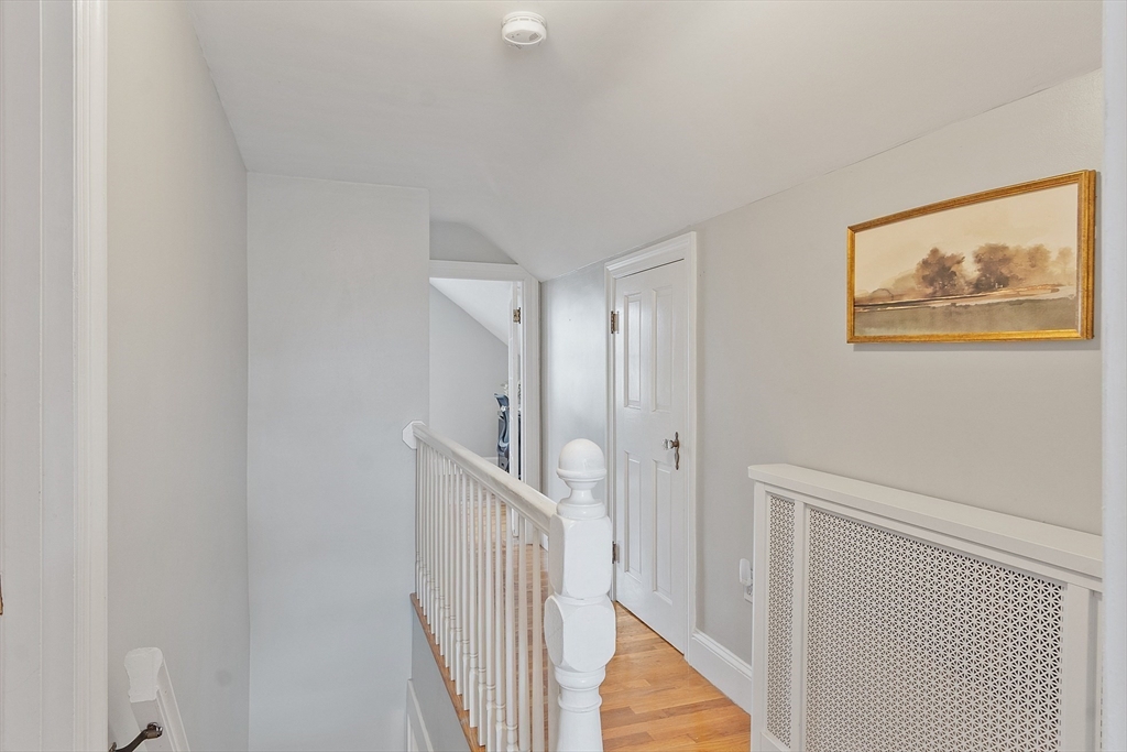 33 Herrick Road North Andover, MA 01845 - Photo 14 of 38 a view of a hallway with a white walls and wooden floor