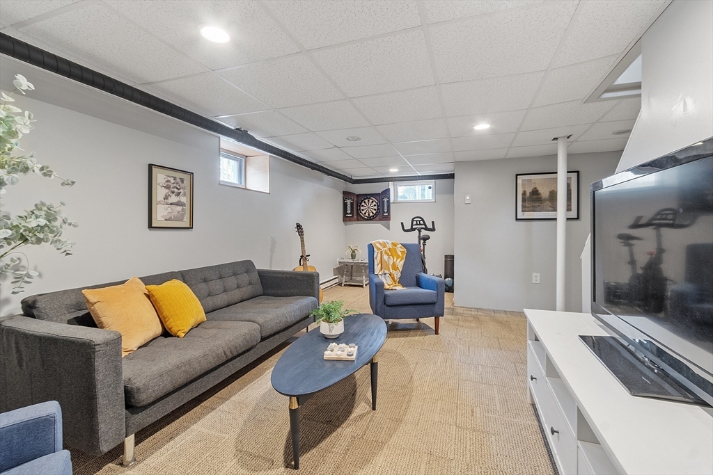 33 Herrick Road North Andover, MA 01845 - Photo 22 of 38 a living room with furniture and painting on the wall