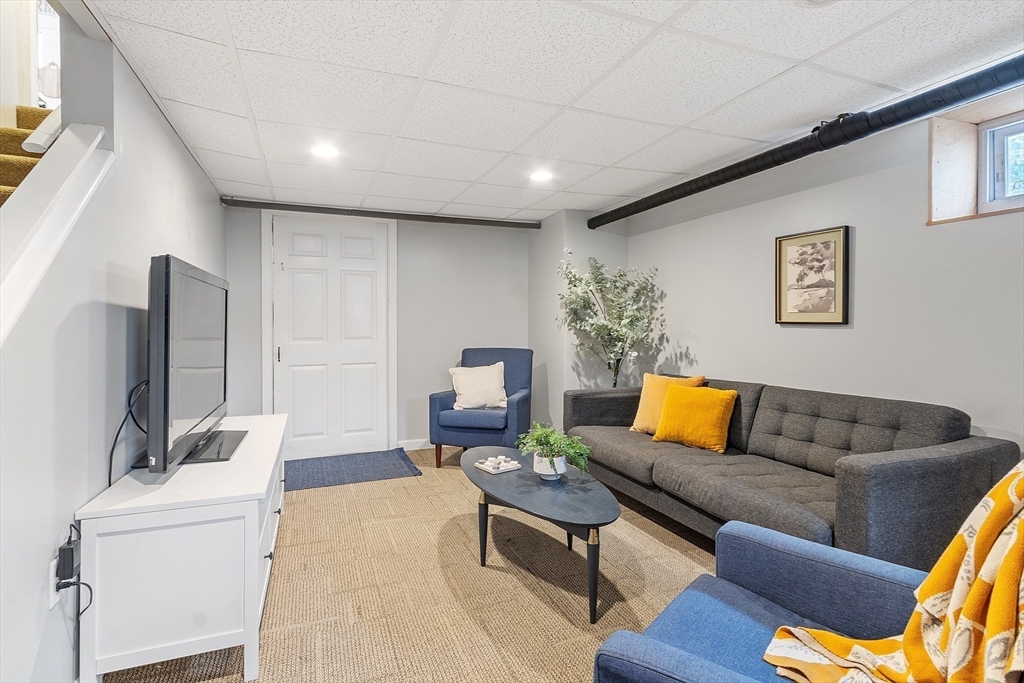 33 Herrick Road North Andover, MA 01845 - Photo 23 of 38 a living room with furniture and a flat screen tv