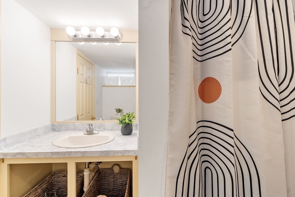 33 Herrick Road North Andover, MA 01845 - Photo 27 of 38 a bathroom with a sink a mirror and a shower