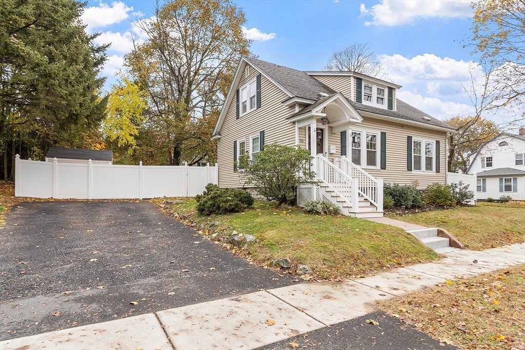 33 Herrick Road North Andover, MA 01845 - Photo 29 of 38 a front view of a house with a yard and garage