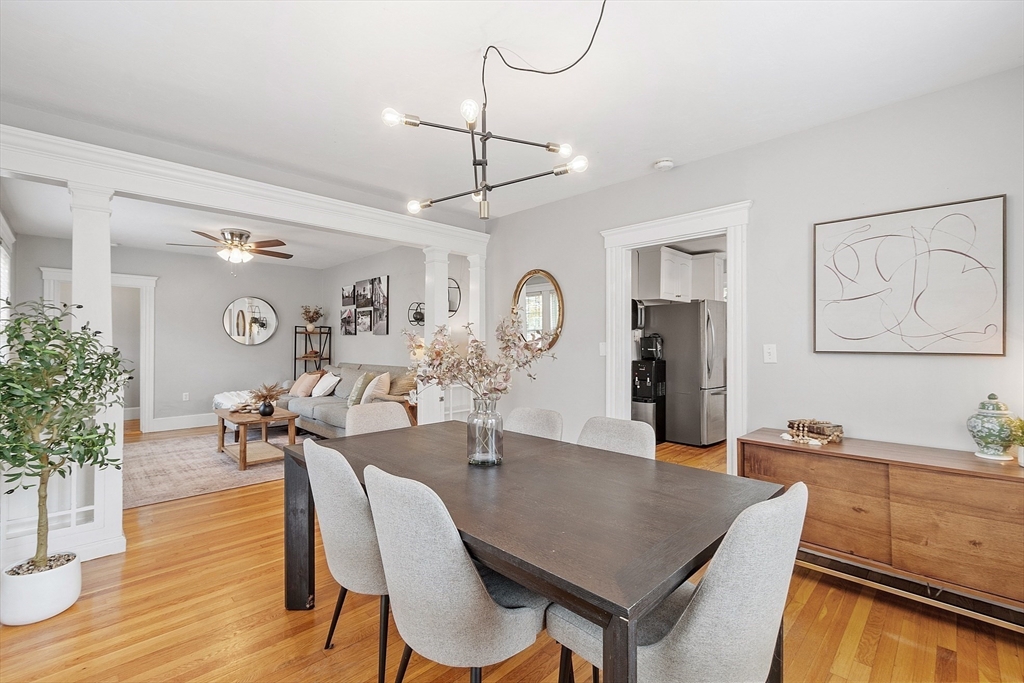 33 Herrick Road North Andover, MA 01845 - Photo 6 of 38 a dining room with wooden floor a chandelier a wooden table and chairs