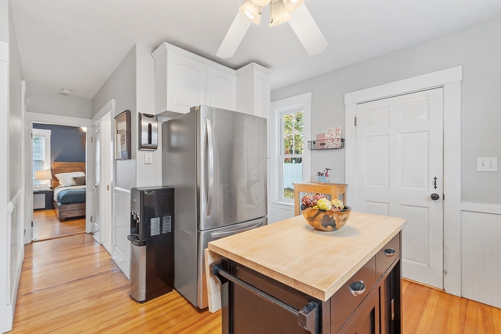 33 Herrick Road North Andover, MA 01845 - Photo 9 of 38 a kitchen with a refrigerator a stove and a wooden floor