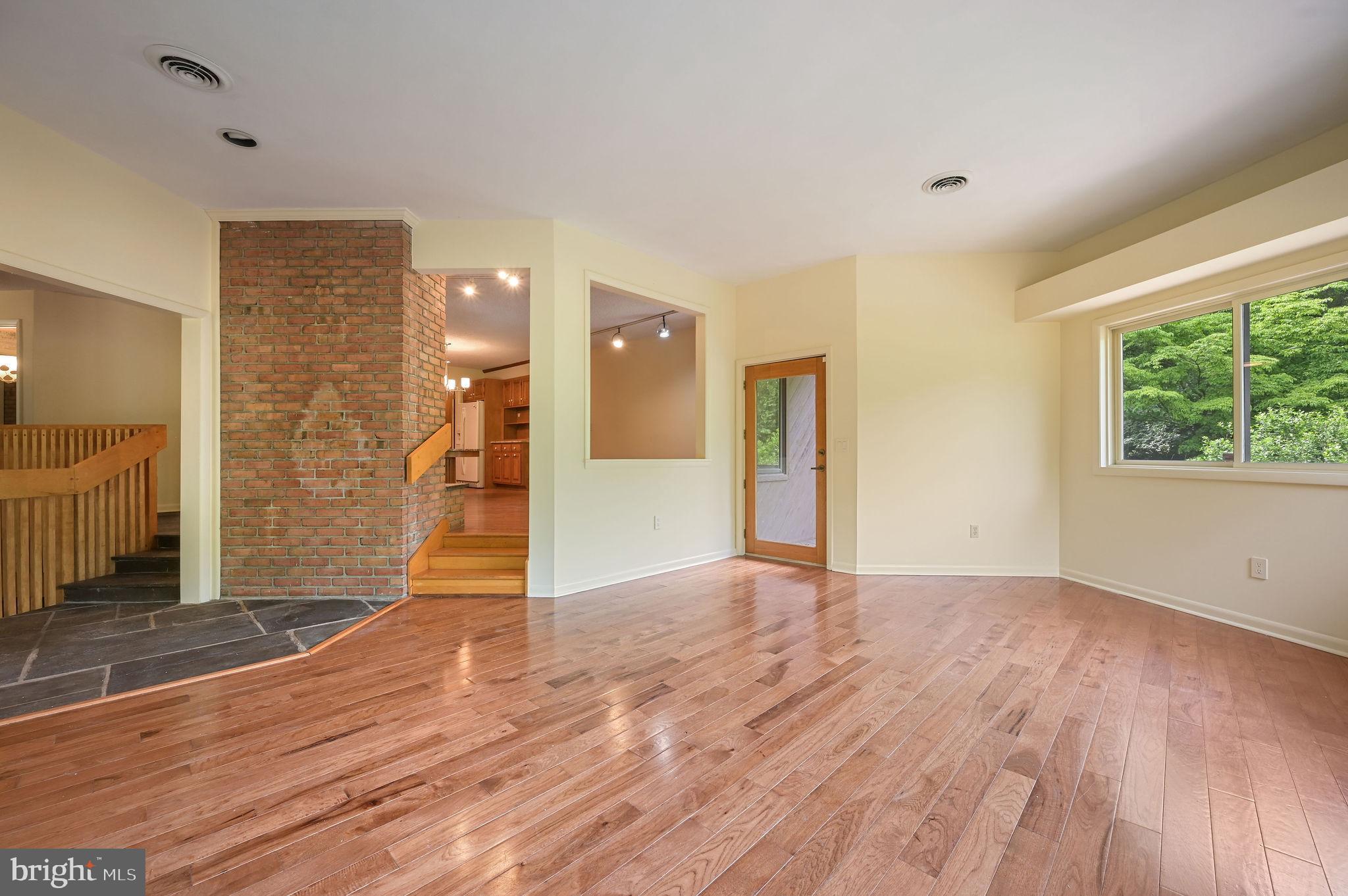 124 Meadowglen Drive Dover, DE 19901 - Photo 11 of 27 a view of an empty room with wooden floor and a window
