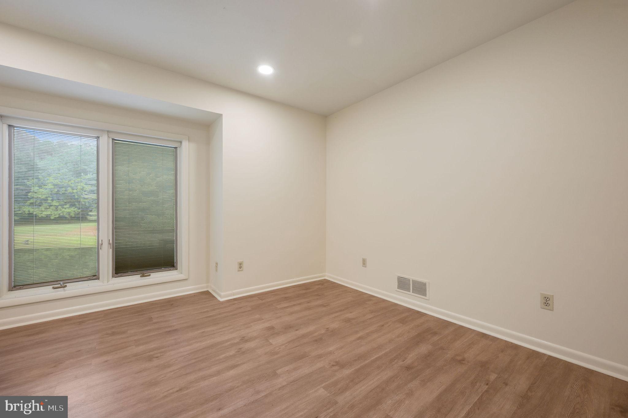 124 Meadowglen Drive Dover, DE 19901 - Photo 16 of 27 an empty room with wooden floor and windows