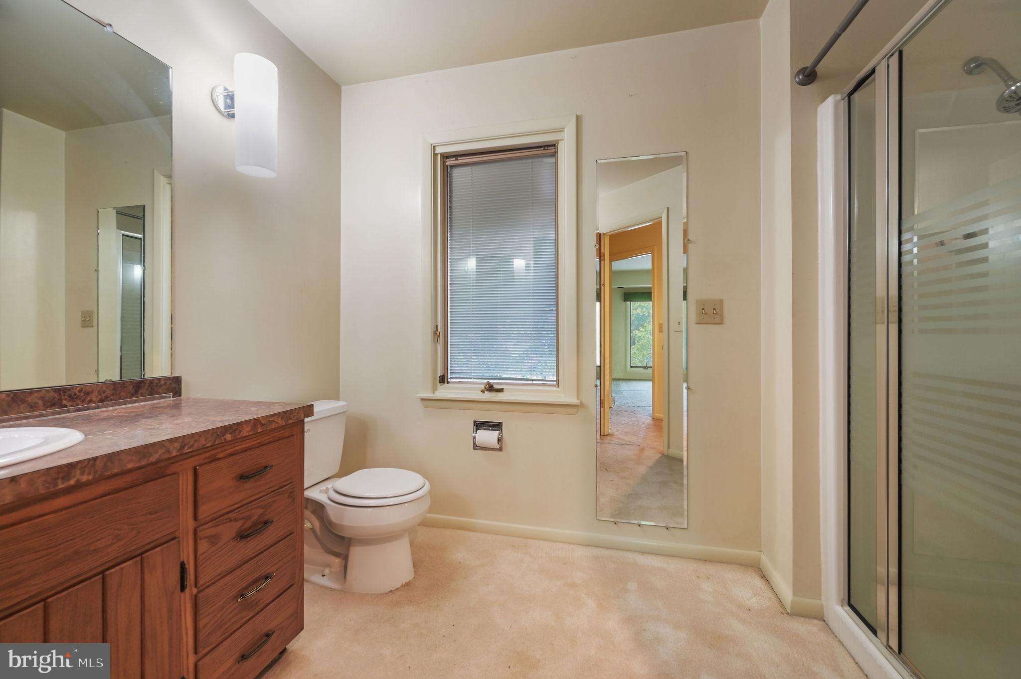 124 Meadowglen Drive Dover, DE 19901 - Photo 20 of 27 a bathroom with a granite countertop toilet a sink and a mirror