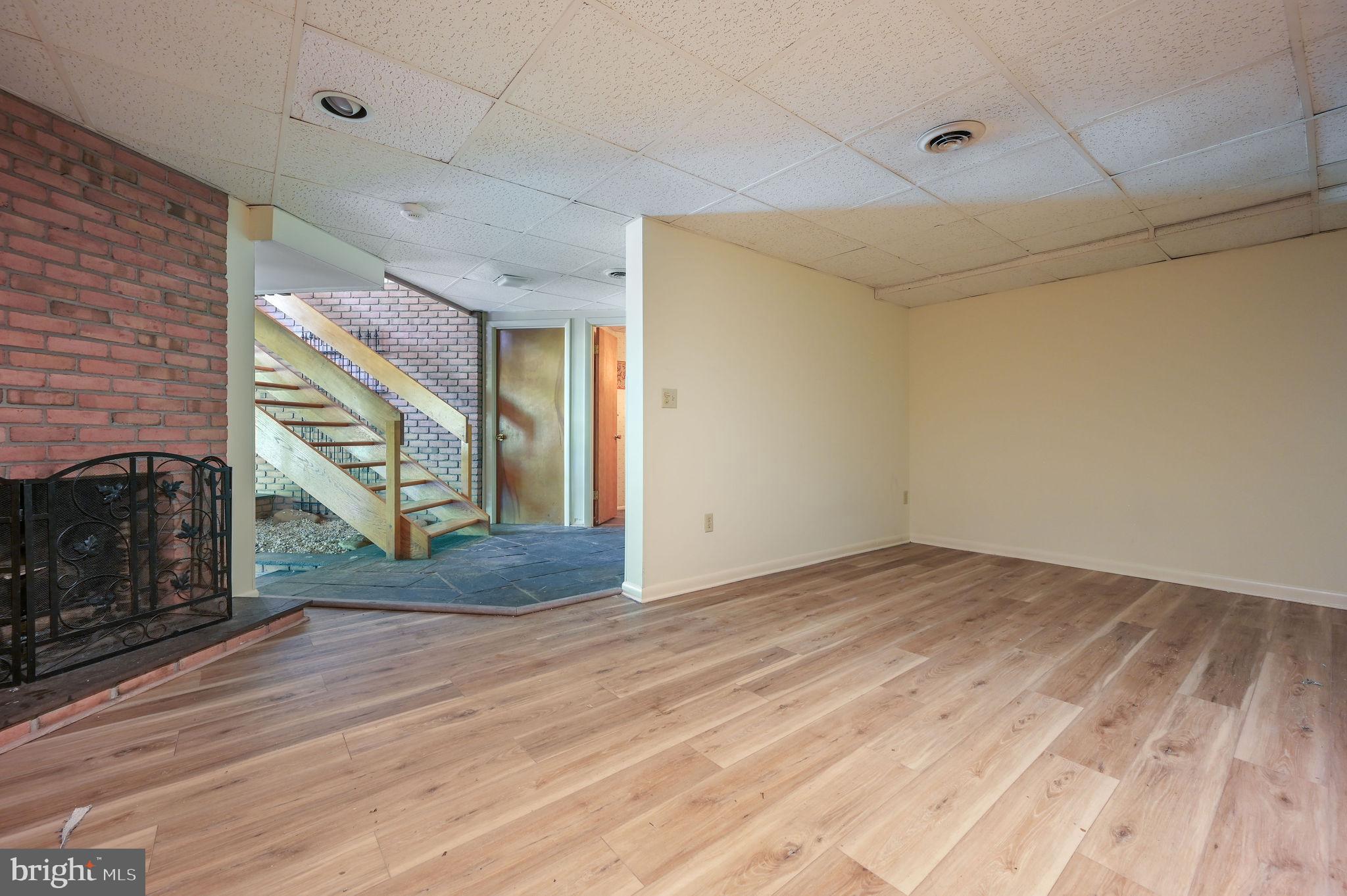 124 Meadowglen Drive Dover, DE 19901 - Photo 24 of 27 a view of empty room with wooden floor and fireplace