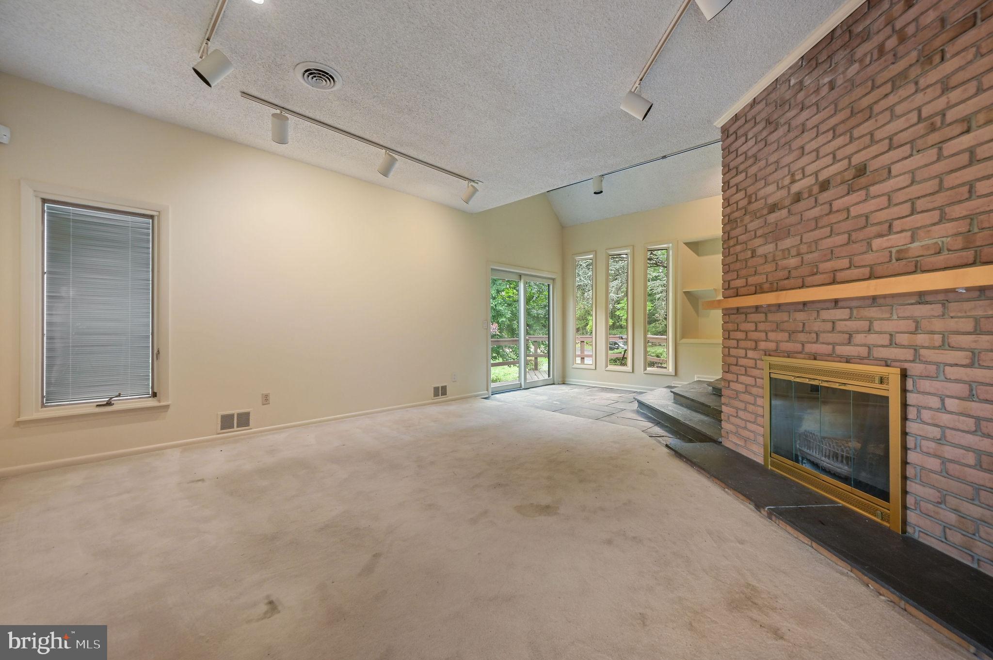 124 Meadowglen Drive Dover, DE 19901 - Photo 8 of 27 a view of empty room with a fireplace and windows