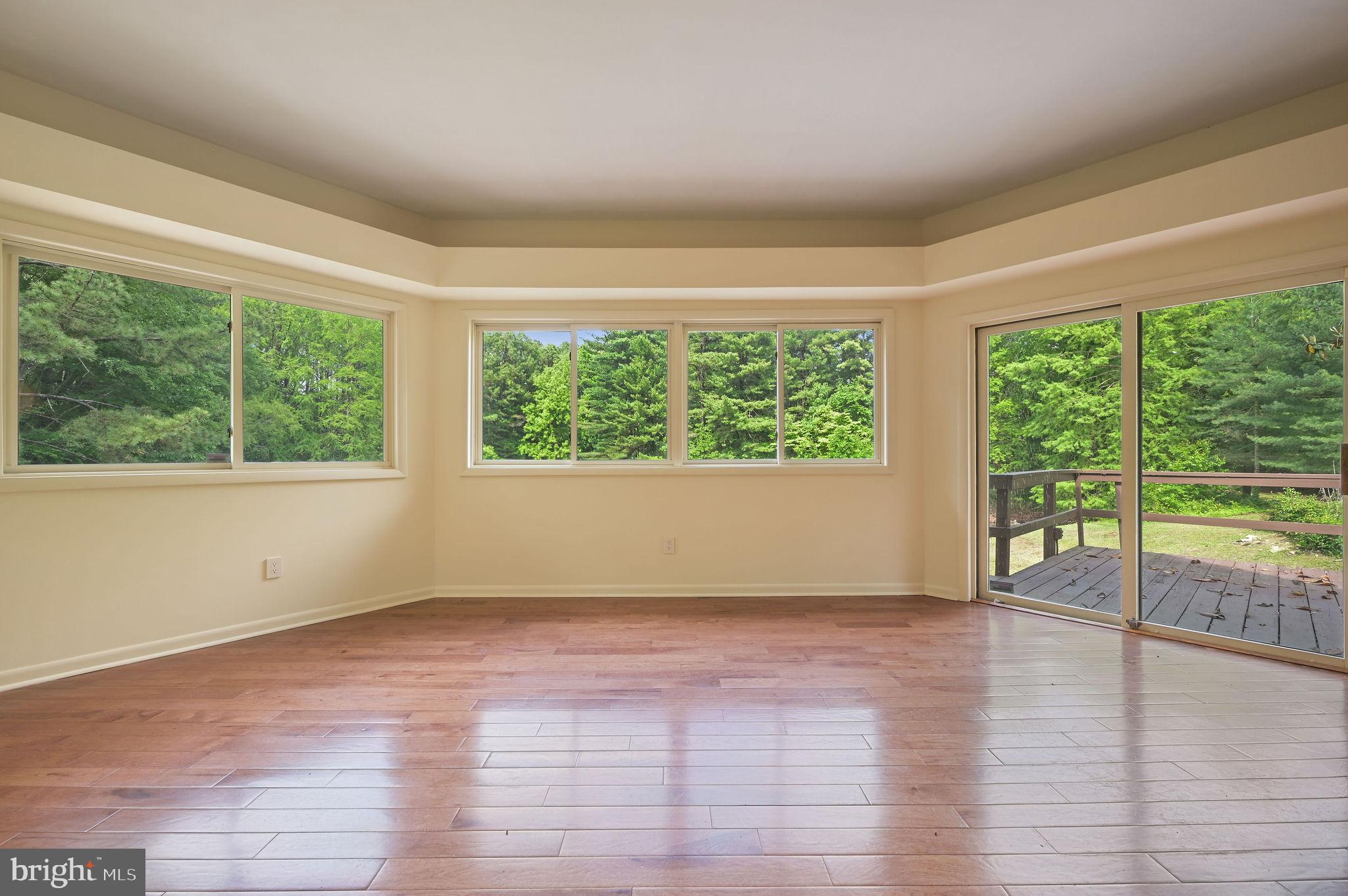 124 Meadowglen Drive Dover, DE 19901 - Photo 10 of 27 a view of an empty room with wooden floor and a window