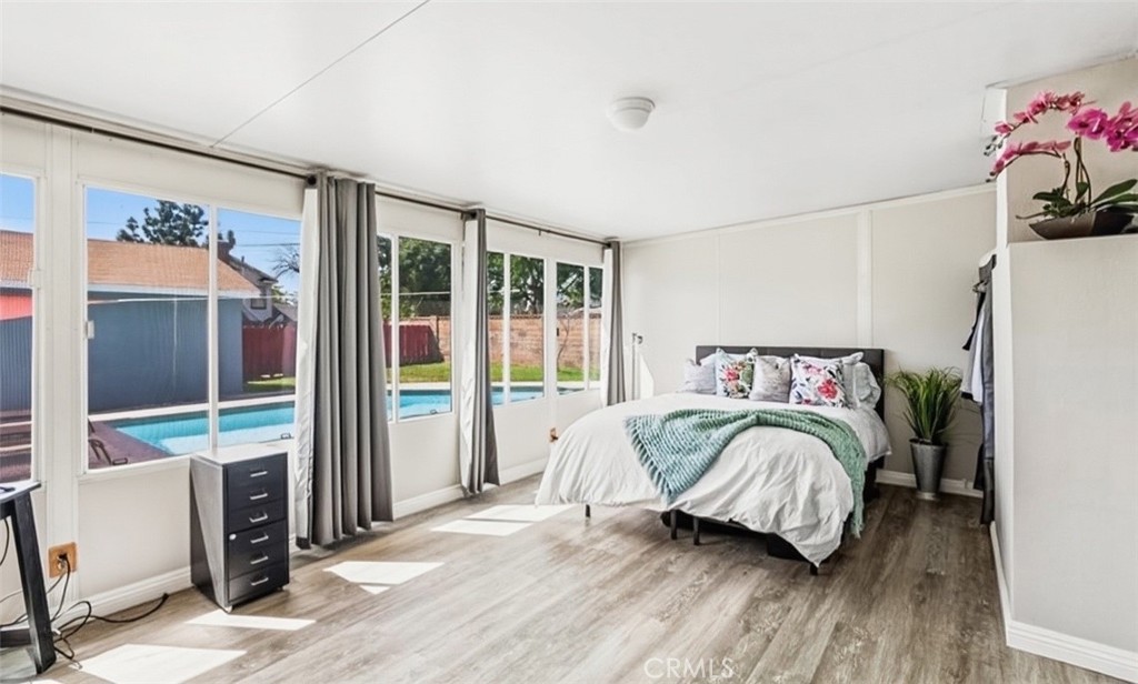 401 North Rennell Avenue San Dimas, CA 91773 - Photo 7 of 9 a bedroom with a bed and a large window