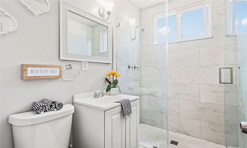 401 North Rennell Avenue San Dimas, CA 91773 - Photo 8 of 9 a bathroom with a sink a toilet and shower