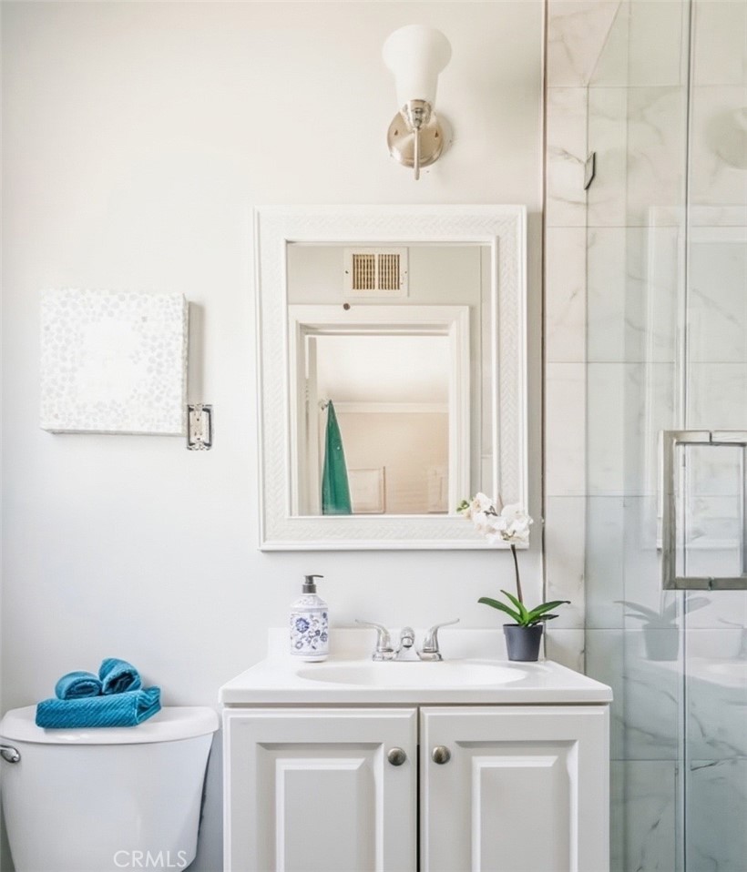 401 North Rennell Avenue San Dimas, CA 91773 - Photo 9 of 9 a bathroom with a granite countertop sink and a mirror