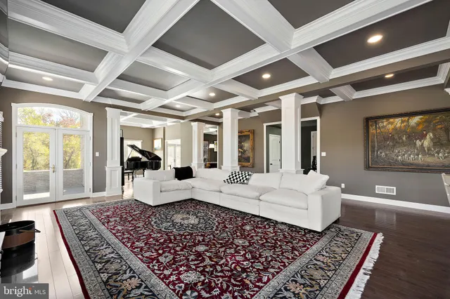 a kitchen with stainless steel appliances granite countertop a stove a refrigerator a sink a dining table and chairs with wooden floor