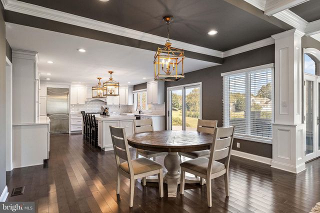 a kitchen with granite countertop a sink a stove a refrigerator and a stove