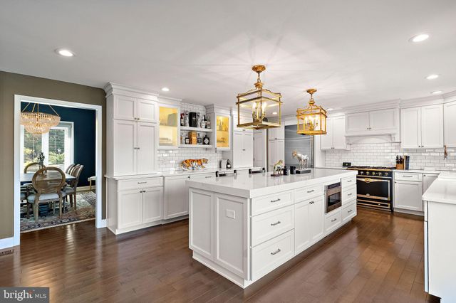 a kitchen with granite countertop white cabinets and appliances