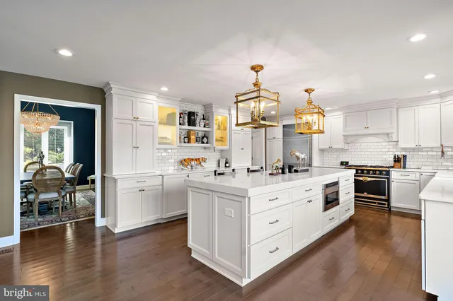 a kitchen with granite countertop white cabinets and appliances